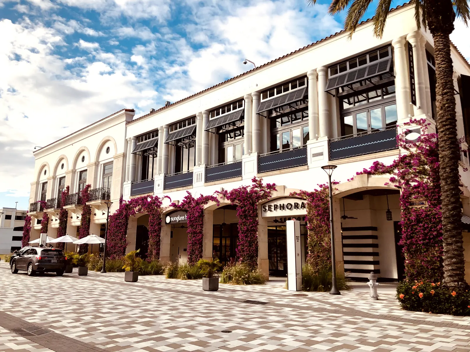 Storefronts draped in bougainvillea at CityPlace, the shopping and dining district on Rosemary Avenue in West Palm Beach.