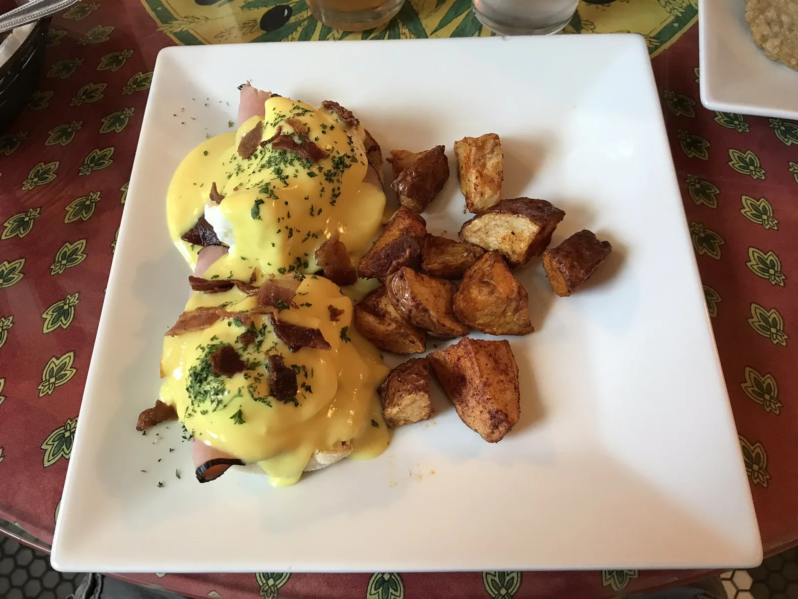 Eggs Benedict with home fries, served at a restaurant in downtown West Palm Beach.