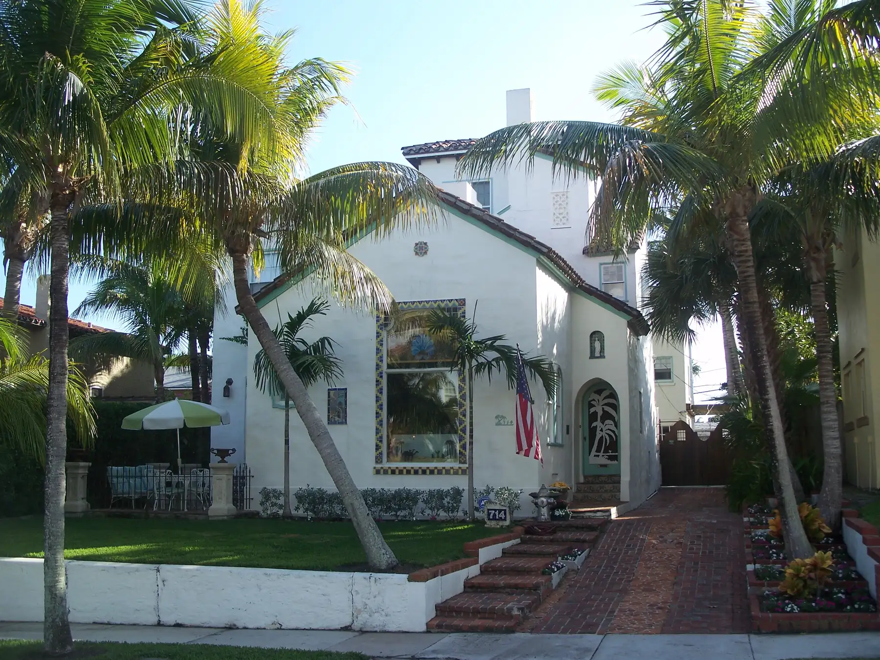 The Rice House, a stucco house shaded by palms in the Flamingo Park Historic Residential District of West Palm Beach.