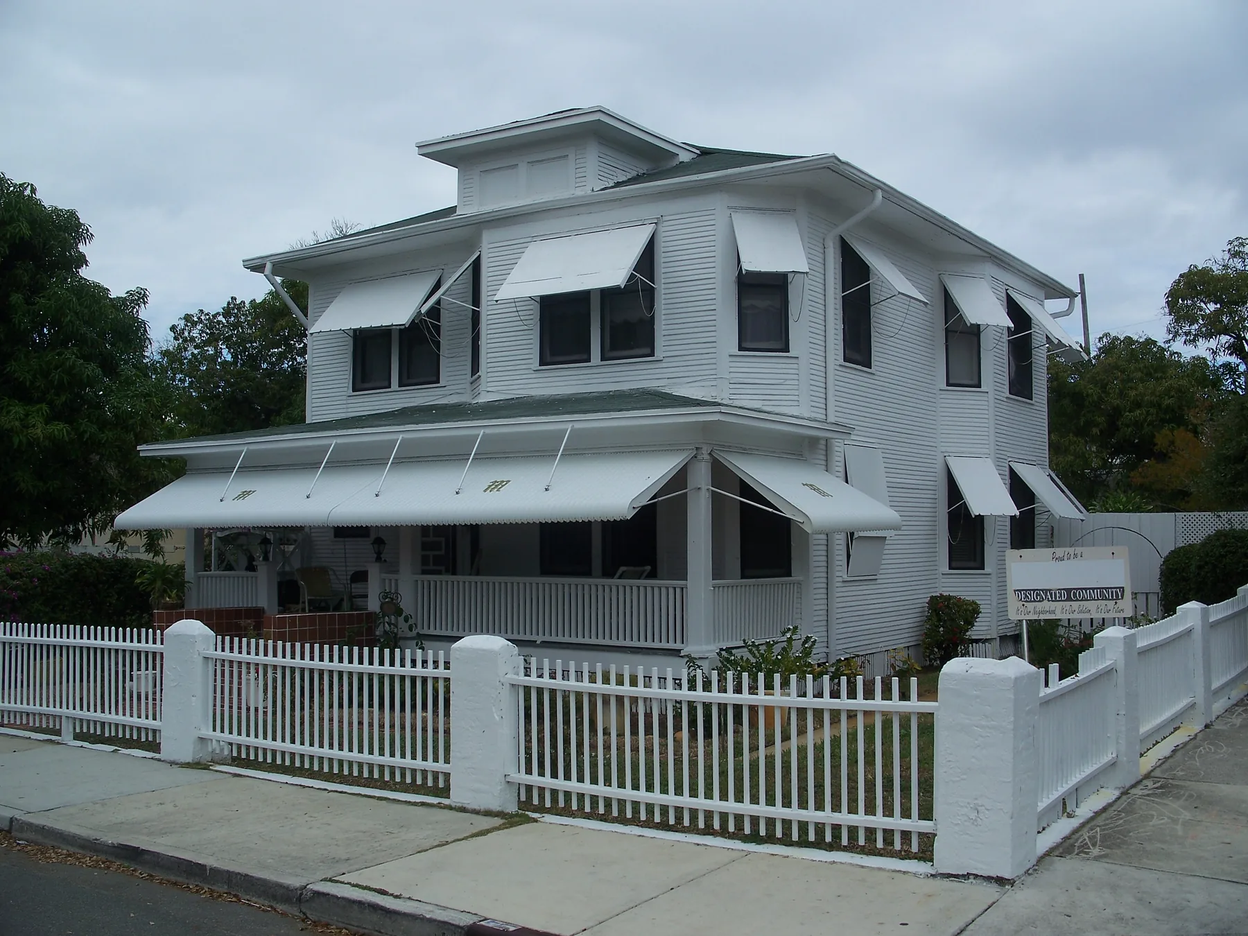 The two-story Mickens House behind its white picket fence in the Northwest Historic District of West Palm Beach.
