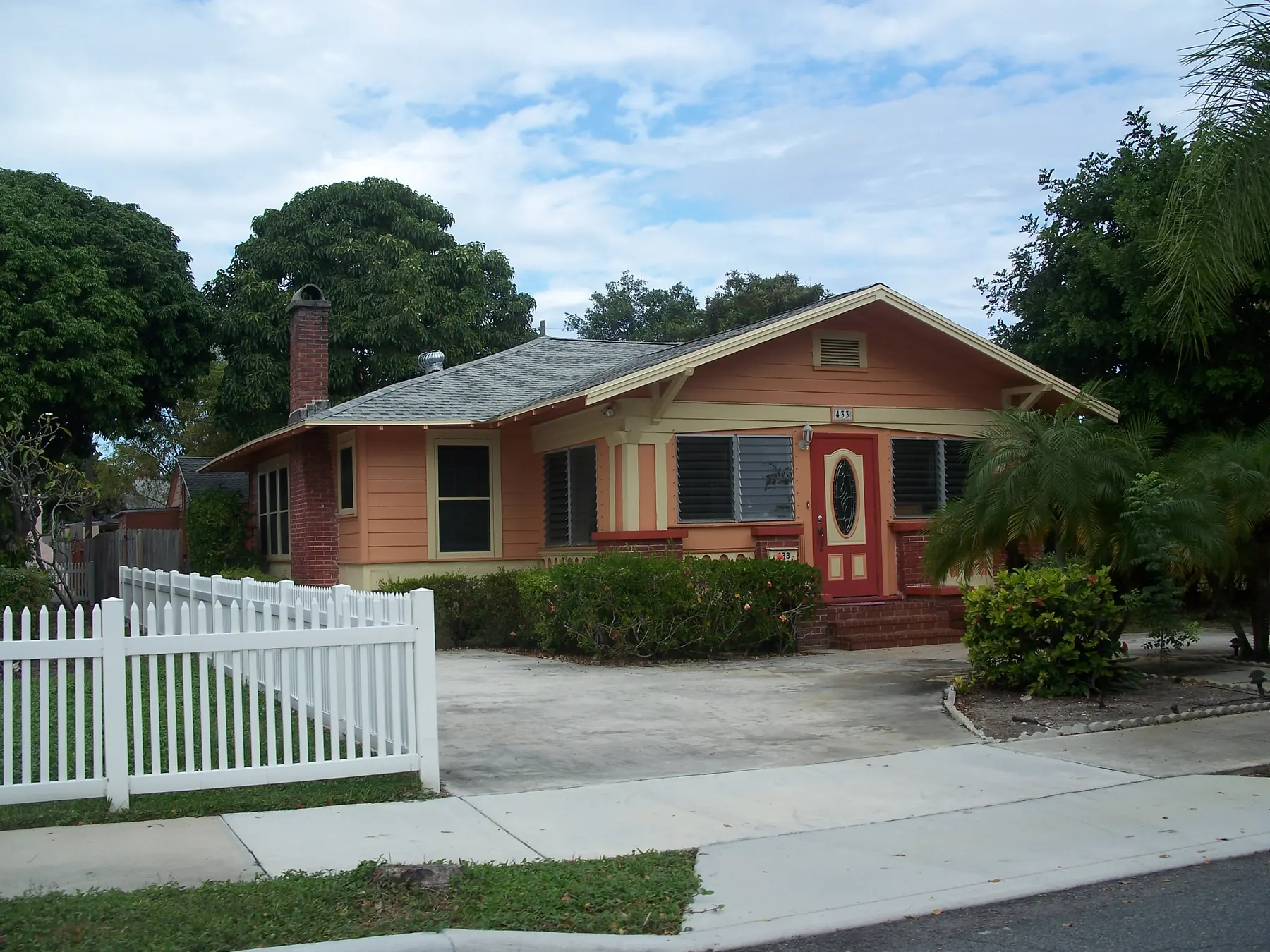 A bungalow with a white picket fence on a street in the Old Northwood Historic District of West Palm Beach.