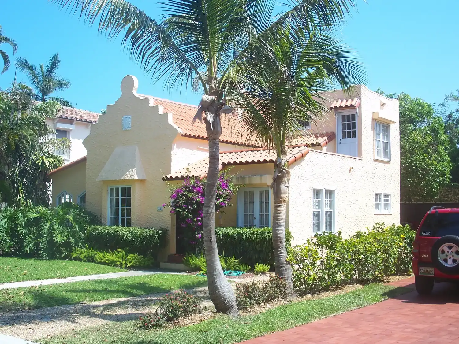 A stucco house with a curved gable and a tile roof in the Prospect Park-Southland Park Historic District of West Palm Beach.