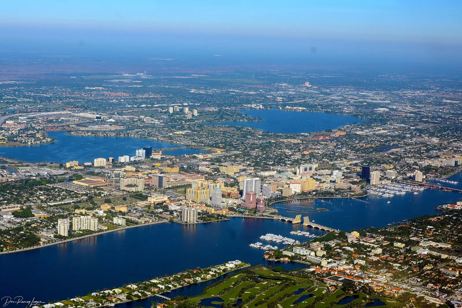 Aerial view of downtown West Palm Beach and the Lake Worth Lagoon, with the Royal Park Bridge and Palm Beach in the foreground.