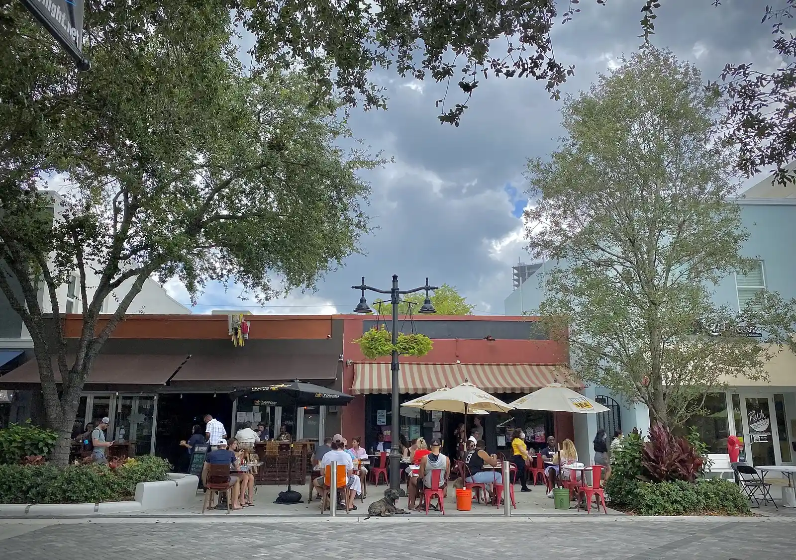 Curbside patio seating outside restaurants on Clematis Street in downtown West Palm Beach.
