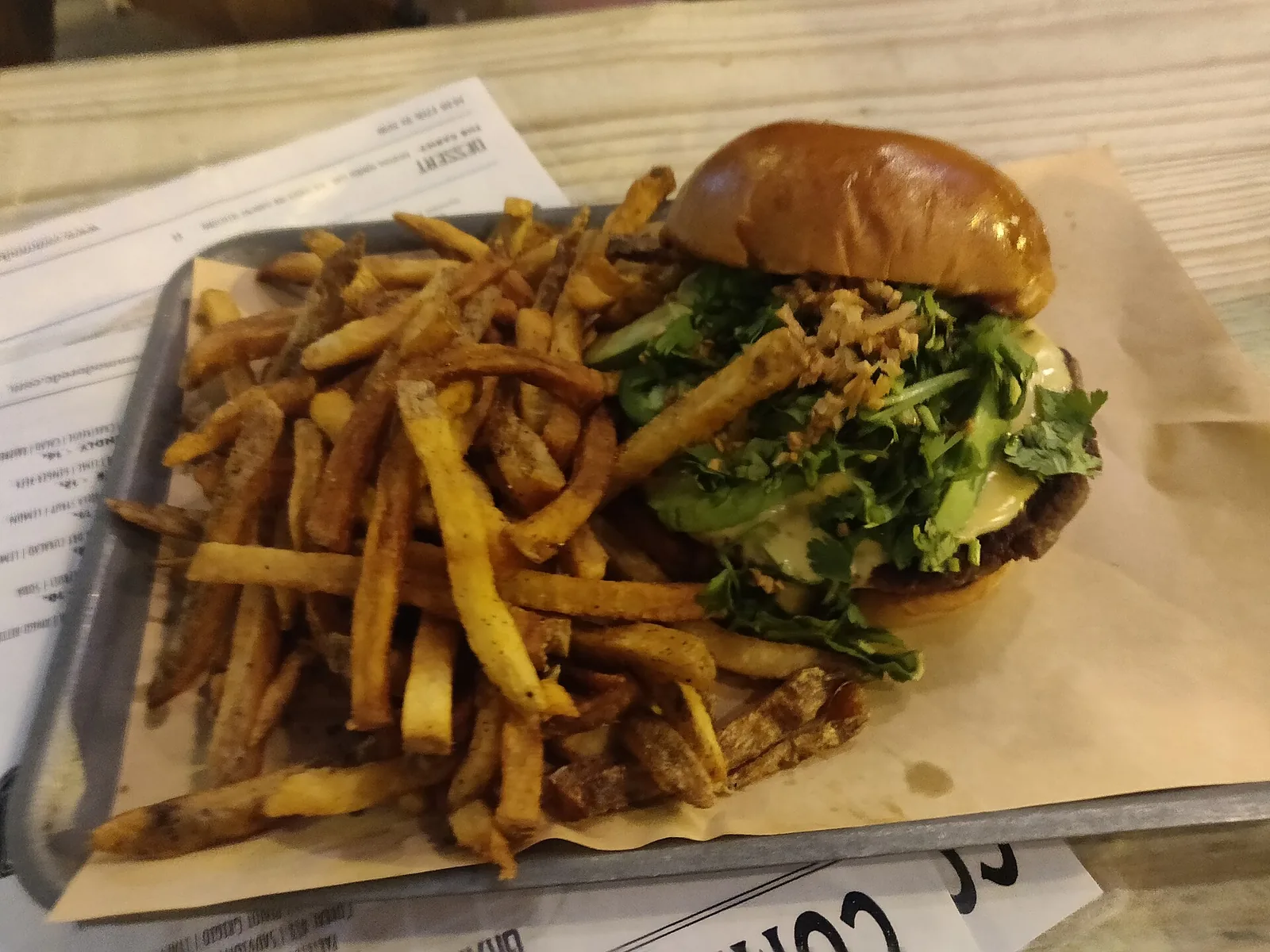 A cheeseburger and fries on a plate, photographed at a restaurant that is not on this list.